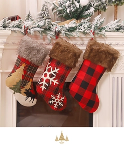 Detailed close-up of plaid Christmas stockings with plush trim and festive embroidery