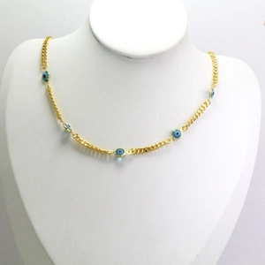 Detailed close-up of golden chain necklace with multiple blue evil eye beads on white display