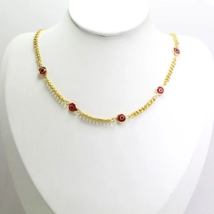 Detailed view of gold chain necklace with five red evil eye charms on a mannequin