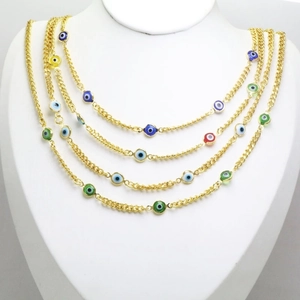 Layered gold evil eye necklace set with colorful enamel beads on a white neck display