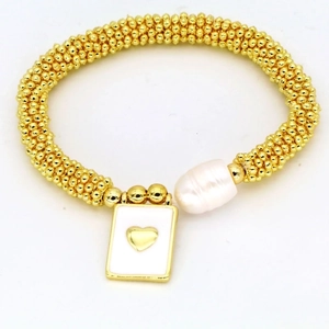 Close-up of golden beaded bracelet with white baroque pearl and heart pendant