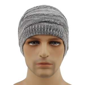 Close-up of winter knit beanie showing grey mixed cable stitch and ribbed cuff texture
