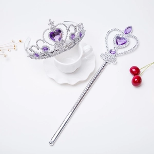Close-up of sparkling purple heart gems on a silver princess tiara and magic wand toy set