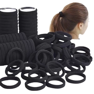 Pack of 4cm seamless high elasticity black fabric hair ties for women on white background