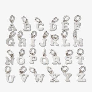 Silver stainless steel alphabet A-Z pendant set with hanging rings on white background