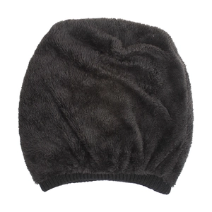 Close-up of black fuzzy knit beanie featuring soft faux fur texture and ribbed cuff detail