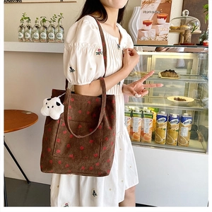 Brown corduroy bucket tote bag with red polka dots and a cute white cow plush charm