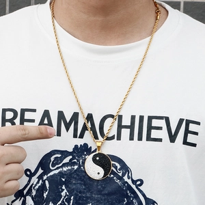 Golden Yin Yang Tai Chi pendant necklace with black and white rhinestones on model