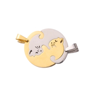 Macro detail of interlocking gold and silver cat pendants for couples on white background