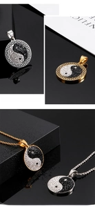 Detail of yin yang pendants with rhinestones, greek key borders and box chain