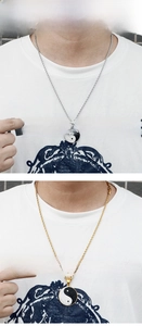 Detail of Yin Yang Tai Chi pendant necklaces in gold and silver with rhinestones
