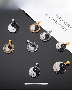Macro view of stainless steel Yin Yang pendants with zircon stones and relief details
