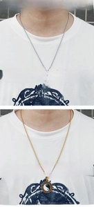 Detailed comparison of gold and silver Tai Chi Yin Yang pendants on twisted chain