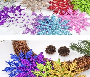 Close-up of colorful 10cm glittery snowflake ornaments on a rustic pine cone wreath