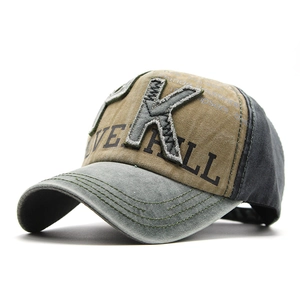 Detailed stitching of vintage khaki baseball cap with embroidered letter K and Live All text