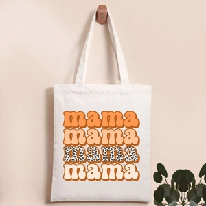 Detail of white canvas tote bag featuring retro mama letters in orange and leopard print