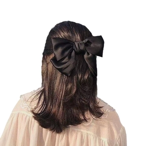 Elegant large black satin bow hair clip for women with a vintage silky texture