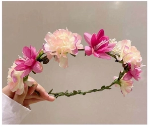 Detail of pink and cream faux flower crown with green vine base for wedding hair decor