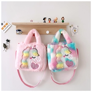 Detail of pink and rainbow tie-dye plush unicorn handbags with soft textures for kids