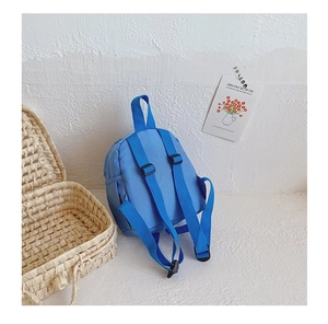 Rear view of blue kids' backpack showing adjustable straps and durable nylon handle