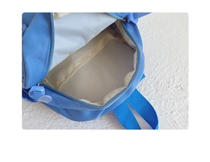 Detailed interior view of a blue nylon kids backpack showing spacious lining and zipper