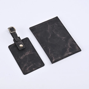 Close-up of marble texture PU leather passport holder and luggage tag travel set