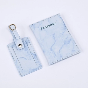 Detail of light blue marble PU leather passport holder and matching luggage tag set