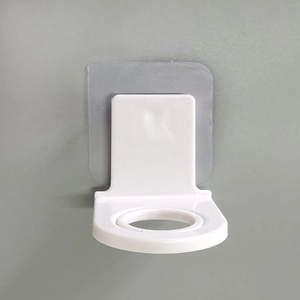Wall-mounted white plastic shampoo bottle holder with transparent adhesive square