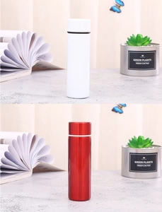 Detail view of mini stainless steel vacuum flasks in white and metallic red finishes