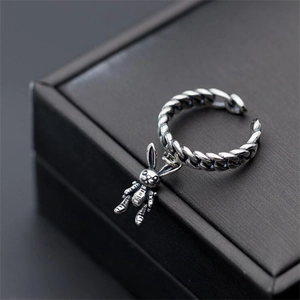 Detail of adjustable silver copper ring featuring rabbit charm and chain texture
