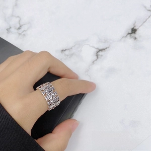 Detailed view of silver alloy open ring with continuous cross pattern engraving
