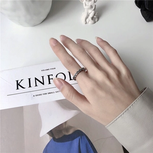 Detail of vintage braided texture ring on a model with Kinfolk magazine background