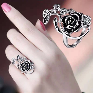 Detail view of a rose-shaped adjustable alloy ring with black petals and silver leaves