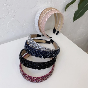 Detail shot of assorted hand-woven crystal bead headbands in multiple shimmering colors