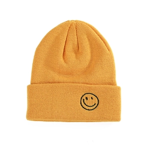 Ginger yellow knitted beanie with black smiley face embroidery and wide cuff style