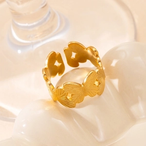 Detailed view of golden butterfly ring with engraved wing patterns and adjustable band