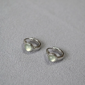 Minimalist silver hoop earrings with a translucent pale green round agate gemstone