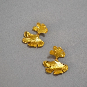 Exaggerated golden ginkgo leaf drop earrings with irregular vintage metal textures