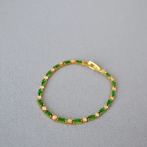 Minimalist gold-plated brass bracelet with green rectangular stones and white zircons