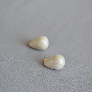 Pear-shaped cream enamel teardrop stud earrings with marble texture and gold plating