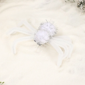 Macro shot of white plush spider hair clip with furry texture for Halloween parties