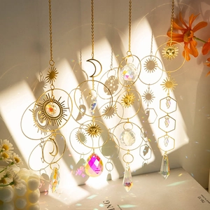 Golden sun star moon crystal suncatcher pendants creating rainbow light on background