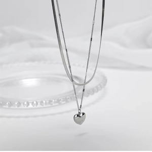 Detail of silver double layer necklace with heart pendant and Love you engraving