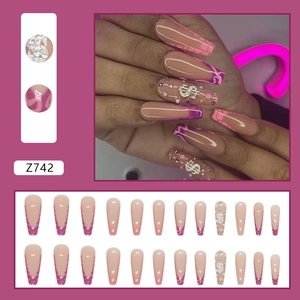 Macro view of Z742 pink ballet press-on nails with sparkling rhinestones and dollar sign