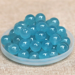 Close-up of sea blue natural stone round beads for DIY jewelry and crafts making