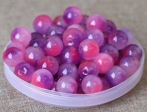 Macro shot of pink and purple gradient round beads for DIY handmade jewelry crafts