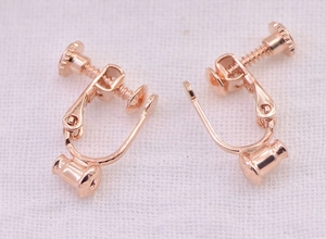 Macro shot of rose gold screw-on earring converter for non-pierced ears with U-shape design