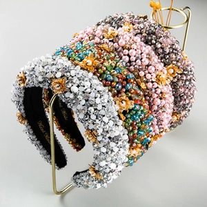 Detail of handcrafted padded headbands with sparkling rhinestones and colorful pearls