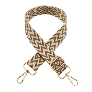 Detail of adjustable woven diamond pattern shoulder strap with gold metal hooks