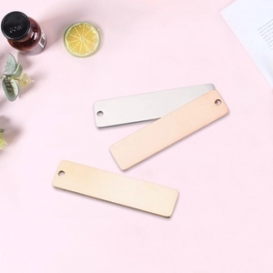 Flat lay of rectangle stainless steel blank tags in gold and silver for DIY engraving